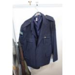A blue single breasted blazer having arm badges and buttons for Burns