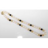 A single row pearl necklet, comprising nine sections of three 8.8 to 9.1mm cultured pearls