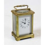 A mid-20th century lacquered brass cased carriage clock, having an enamelled dial with Roman