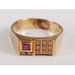 A yellow metal rectangular signet ring, the head set with one rectangular cut ruby and 11 round