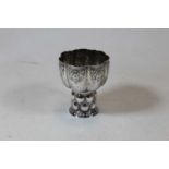 An Edwardian silver communion goblet, having melon shaped bowl with repousee floral decoration, 4.