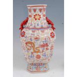 A Chinese export vase of shaped octagonal form, enamel decorated with a gilt dragon with further