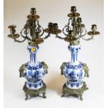 A pair of Chinese export blue & white and brass mounted five branch table candelabra, the brass