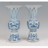 A pair of Chinese export blue & white gu shaped vases having a flared rim to slender neck, square