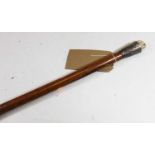 A late 19th/early 20th century gentleman's walking stick, the white metal handle surmounted by a