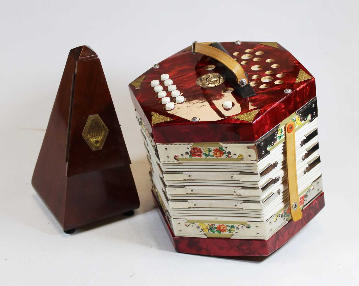 A German Scholer accordion together with a French Paquet mahogany cased metronome, height 23cm