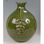 A large Chinese stoneware green glazed vase, having a shaped rim with bulbous body and raised