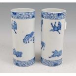 A pair of Chinese blue & white vases each of cylindrical form decorated with various horses within