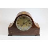 An early 20th century mahogany cased eight day mantel clock, the silvered dial showing Roman