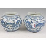 A pair of Chinese export blue & white jardinières, each of squat circular form, decorated with