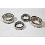 A pair of silver and embossed oval napkin rings, Sheffield 1906, together with a pair of silver