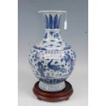 A Chinese export stoneware vase having a flared rim to a slender neck and bulbous lower body