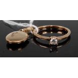 A modern 9ct gold diamond solitaire ring, the four-claw set brilliant weighing approx 0.16 carats,