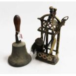 A brass hand bell stamped WH with turned wooden handle and a small brass & enamelled fireside