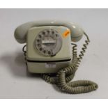 A cream plastic cased wall mounted telephone