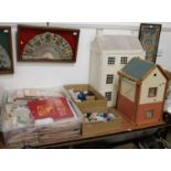 A painted Georgian style three storey dolls house, together with a further dolls house, two boxes of