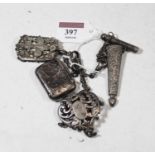 An Edwardian silver chatelaine, having three chains suspending a vesta, aide-memoire, and scissor