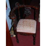 A pair of contemporary carved walnut tub corner chairs, each in the 18th century style, with pink