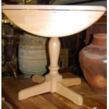 A contemporary beech dropflap pedestal kitchen table