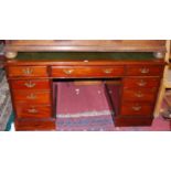 A late Victorian mahogany and green leather inset twin pedestal writing desk, of good size, having
