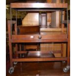 An Art Deco walnut and figured walnut Besway three-tier hinged tea trolley, width 76.5cm