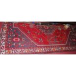 A Turkish woollen red ground rug, having all over geometric floral decorated ground, 244 x 158cm