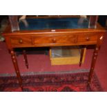 A Victorian mahogany and gilt tooled leather inset three drawer writing table, on ring turned