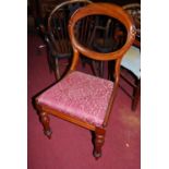 A set of four mid-Victorian mahogany balloon back dining chairs, having red upholstered drop-in