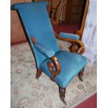 A mid-Victorian mahogany and upholstered scroll armchair, raised on turned forelegs to pot