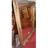 A large contemporary floral gilt framed bevelled rectangular wall mirror, 160 x 129cm