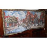 A European machine woven needle work wall hanging depicting a Dutch canal scene, 72 x 182cm,