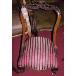 An early Victorian carved rosewood framed and striped upholstered single salon side chair