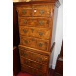 An early 20th century figured walnut and crossbanded chest on chest in the George II style, the