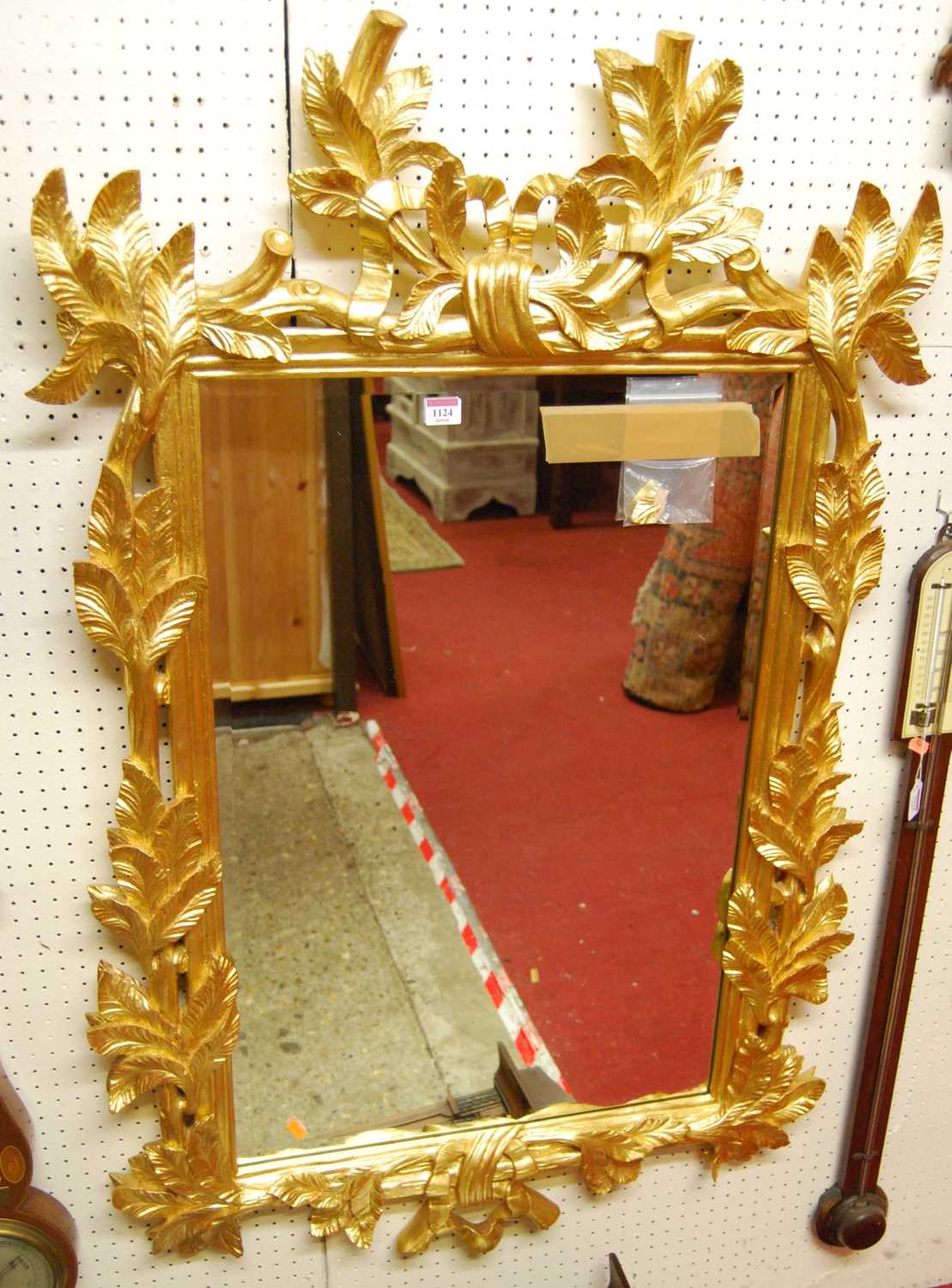 A contemporary French style floral pierced gilt framed bevelled rectangular wall mirror, 124 x 81cm