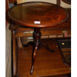 A contemporary mahogany circular low pedestal tripod occasional table, dia. 45cm