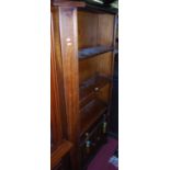 A reproduction mahogany freestanding open bookshelf, having single long lower drawer over conforming