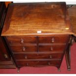 A 19th century mahogany hinge top chest commode, with twin upper cupboard doors over two dummy