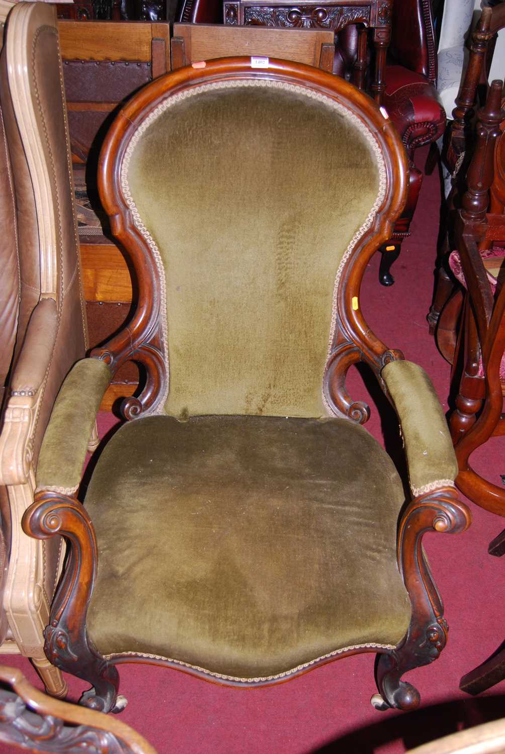 A mid-Victorian mahogany show frame scroll armchair, width 70cm