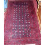 A small Persian woollen red ground Bokhara rug, 174 x 100cm