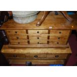 A contemporary hardwood low chest, fitted with nine short drawers, w.90,5cm; together with a near-