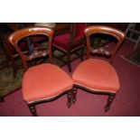 A set of six mid-Victorian mahogany balloon back dining chairs, each having upholstered stuff over