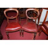 A set of six mid-Victorian mahogany balloon back dining chairs, each with red rexine upholstered