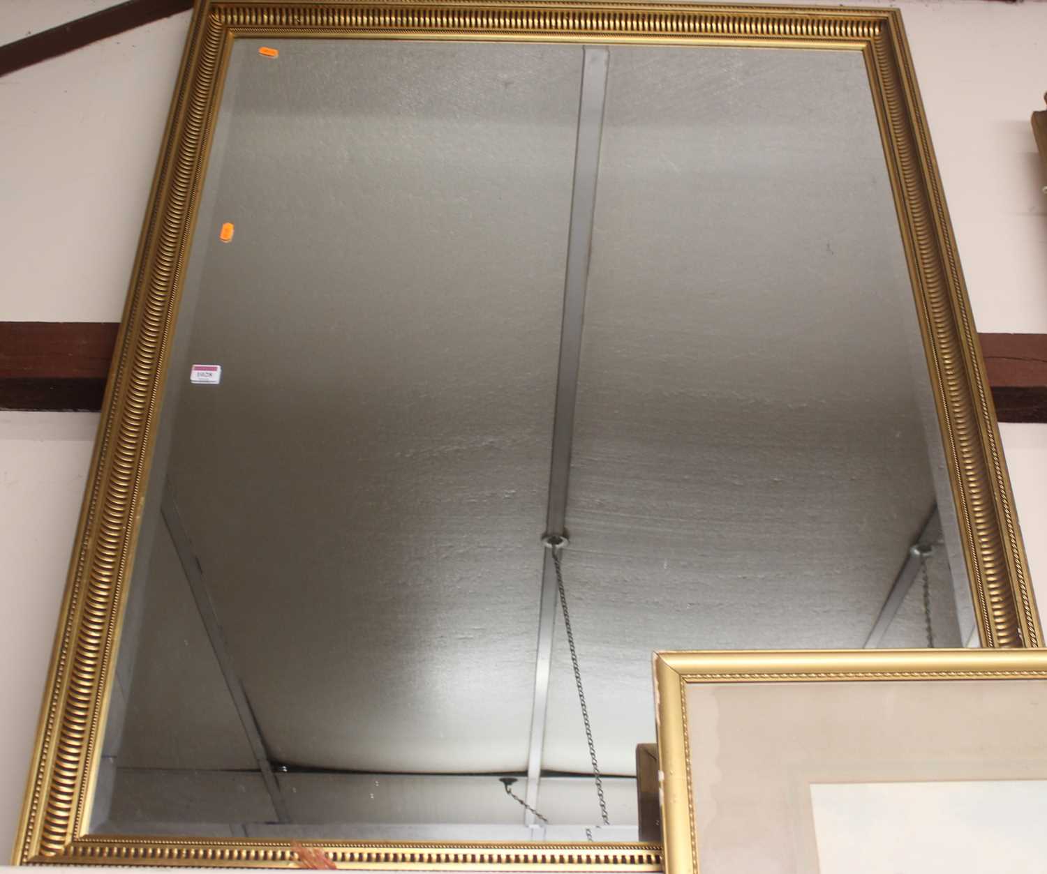A gilt framed and bevelled rectangular wall mirror, 126 x 100cm