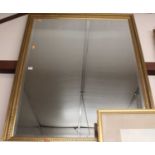 A gilt framed and bevelled rectangular wall mirror, 126 x 100cm