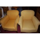 A pair of circa 1900 and later mustard upholstered armchairs, each raised on splayed forelegs, width