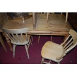 A modern pine round cornered farmhouse style kitchen table, having single end drawer, raised on