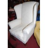 A contemporary mahogany framed and cream floral upholstered wing back scroll armchair, width 80cm