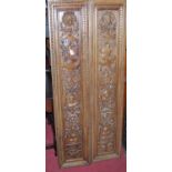 A pair of circa 1900 Continental relief carved walnut and narrow rectangular wall panels, each 158.5