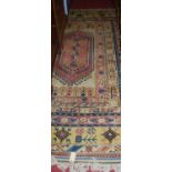 A Turkish cream ground woollen rug, the central floral motif within numerous trailing tramline