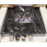 A Star Wars wall hanging display, with Star Wars shot glasses